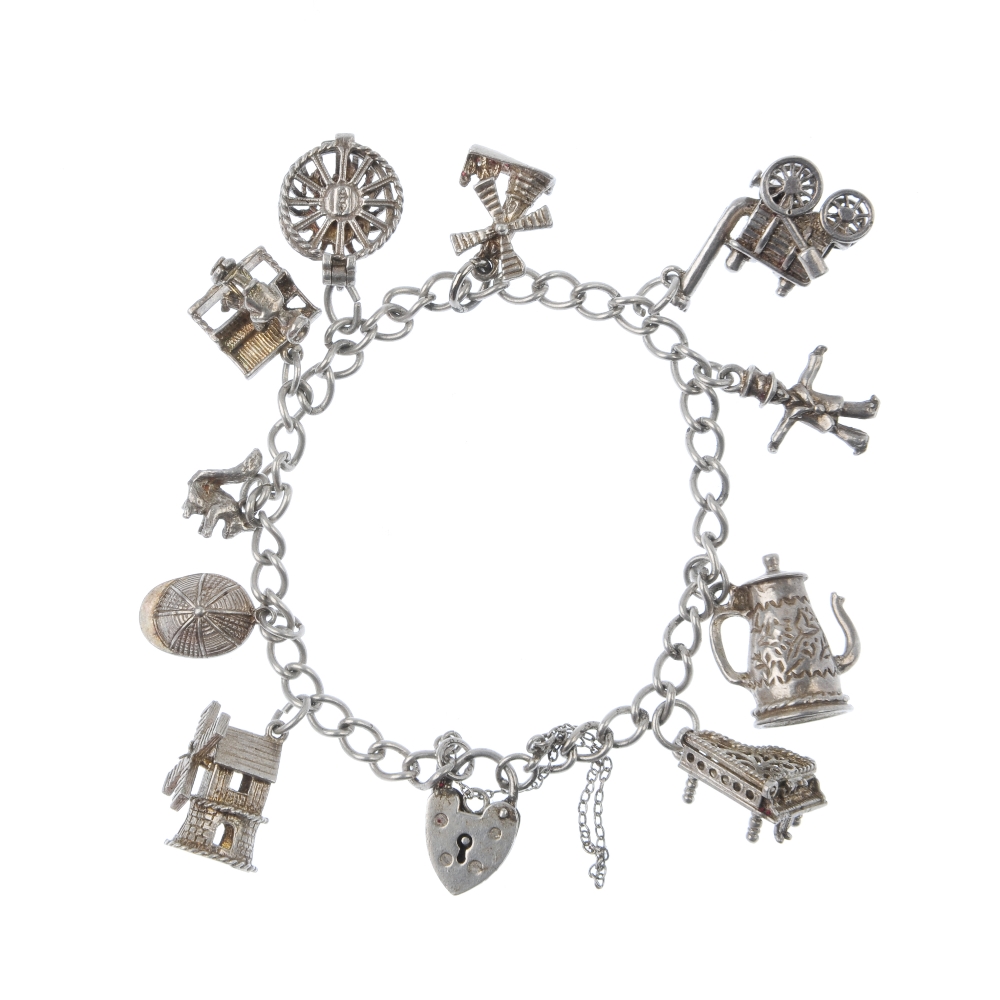 Five charm bracelets. Suspending a total of fifty charms, to include a set of traffic lights