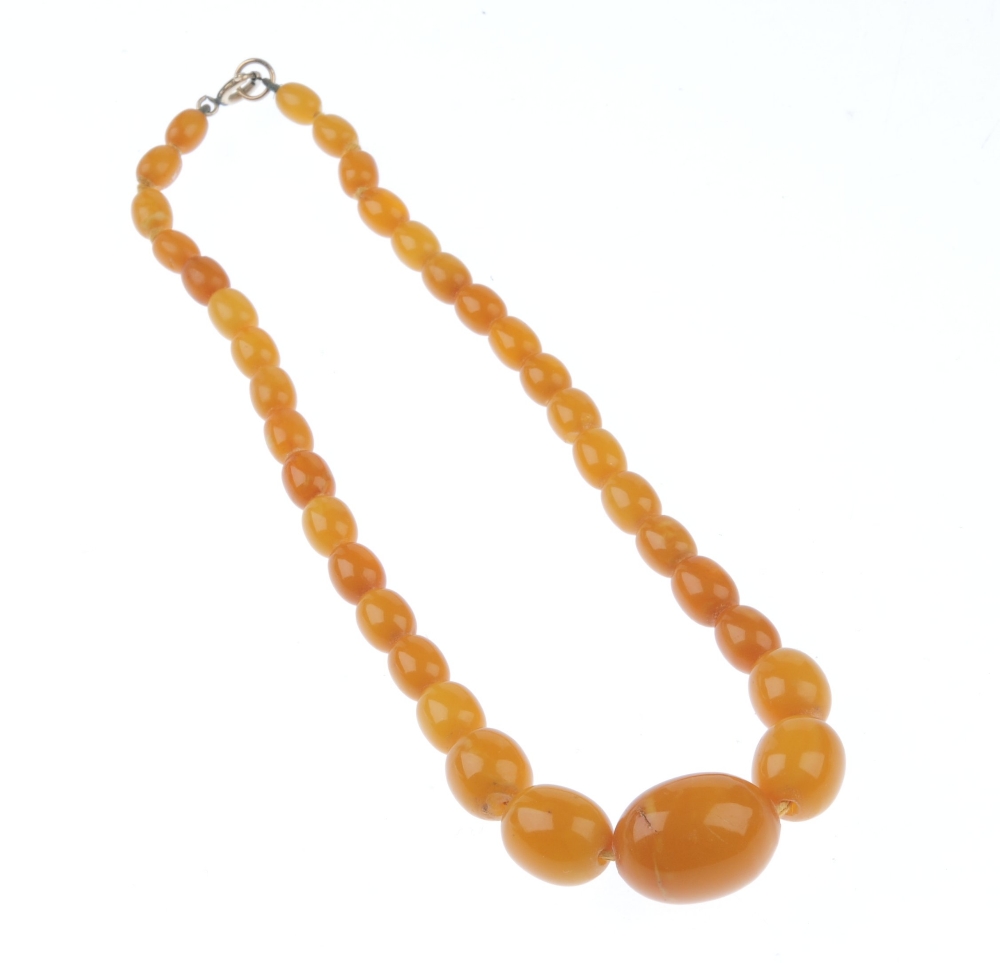 A natural amber necklace. Designed as thirty-five graduated oval-shape beads measuring 8 to 2. - Image 2 of 5
