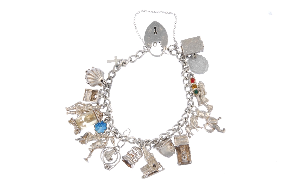 A charm bracelet. Designed as a series of nineteen charms, to include a shell and a steam train, - Image 2 of 2