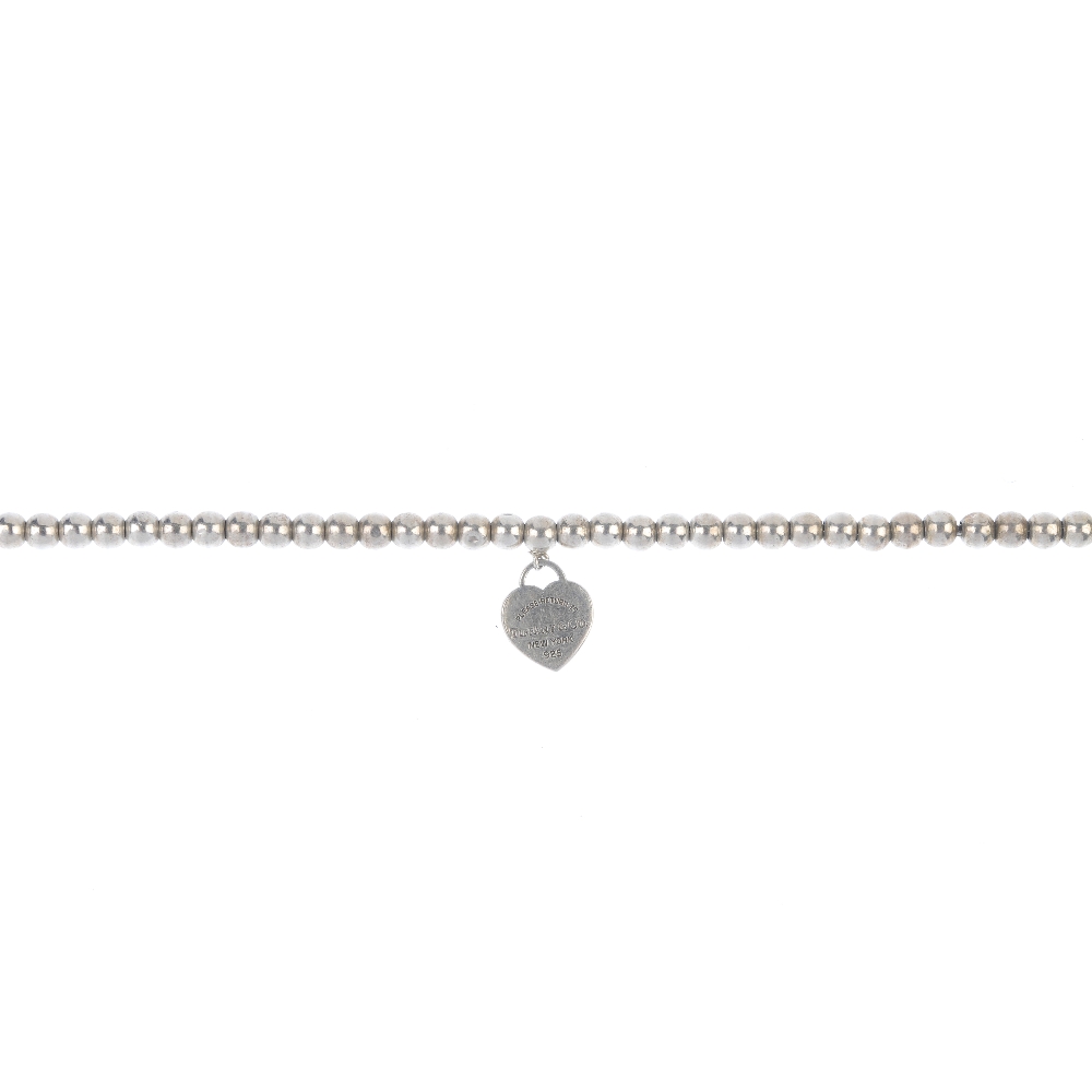 TIFFANY & CO. - a 'Return to Tiffany' bracelet. The miniature heart-shaped charm with 'Return to