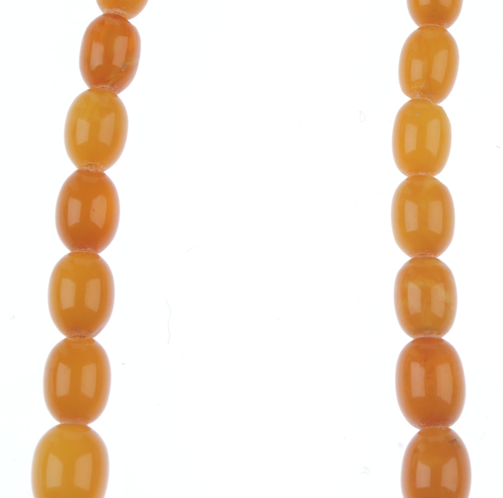 A natural amber necklace. Designed as thirty-five graduated oval-shape beads measuring 8 to 2. - Image 5 of 5