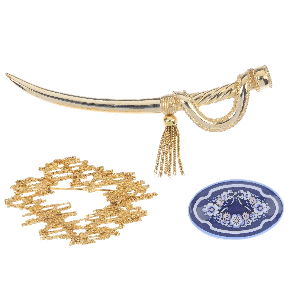 Three designer brooches. The first a Christian Dior brooch in the form of a gold-tone cutlass,