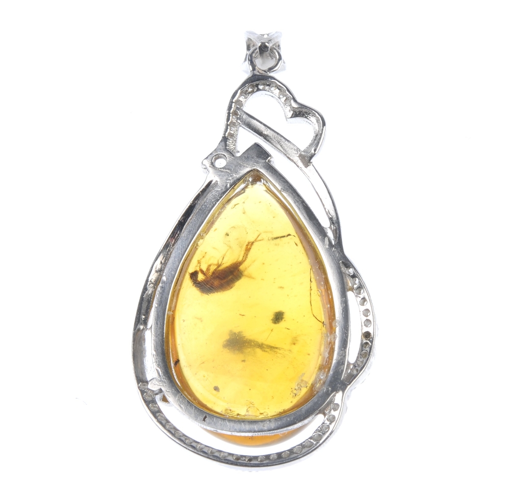 A natural Burmese amber pendant with inclusion. The pear-shape amber cabochon, with clearly - Image 3 of 3