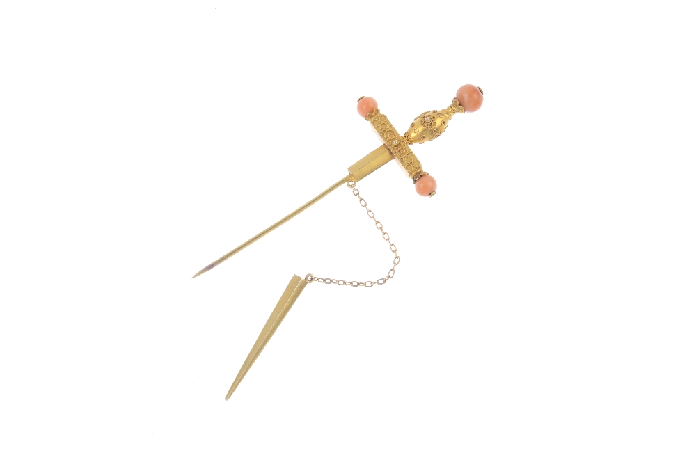 A late 19th century gold coral set stickpin. Designed as a sword with cannetille detail to the - Image 2 of 2