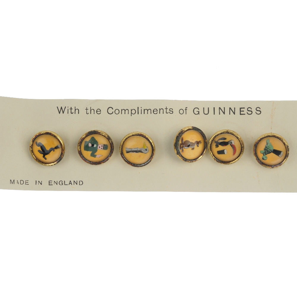 A set of six dress studs. Of circular outline, each depicting a character from the Guinness
