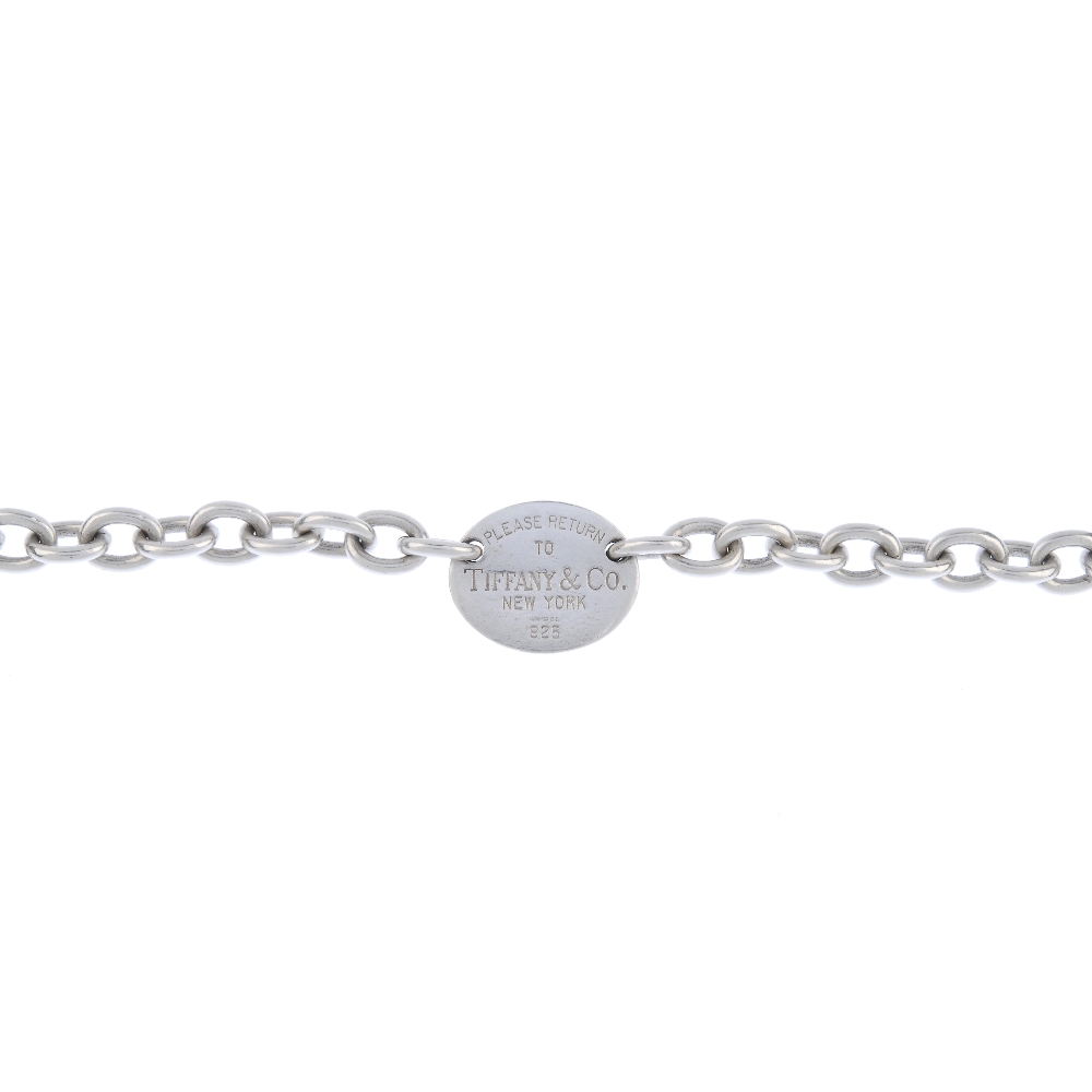 TIFFANY & CO. - a bracelet. Designed as a central oval panel with 'Please return to Tiffany & Co.