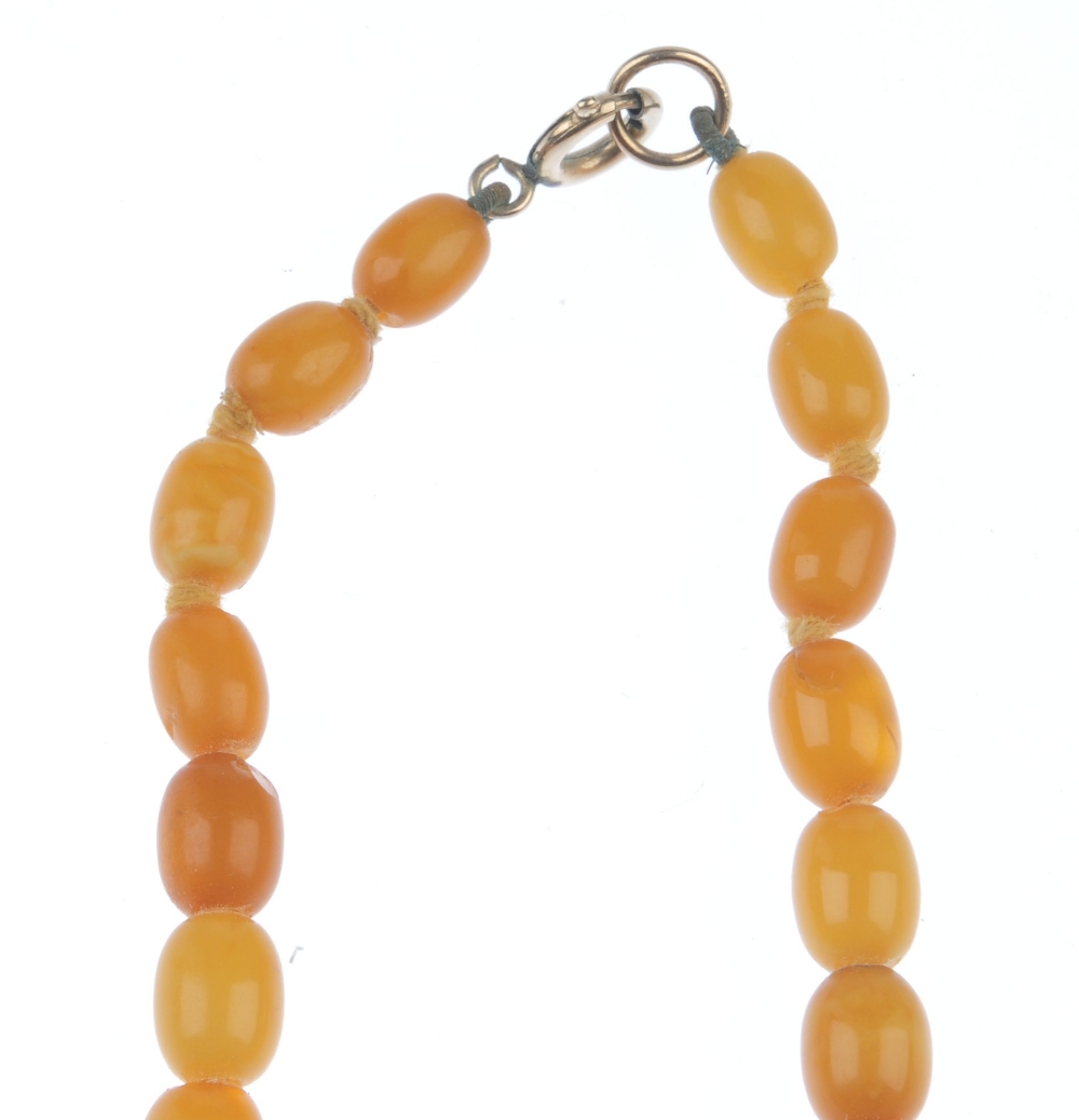 A natural amber necklace. Designed as thirty-five graduated oval-shape beads measuring 8 to 2. - Image 4 of 5