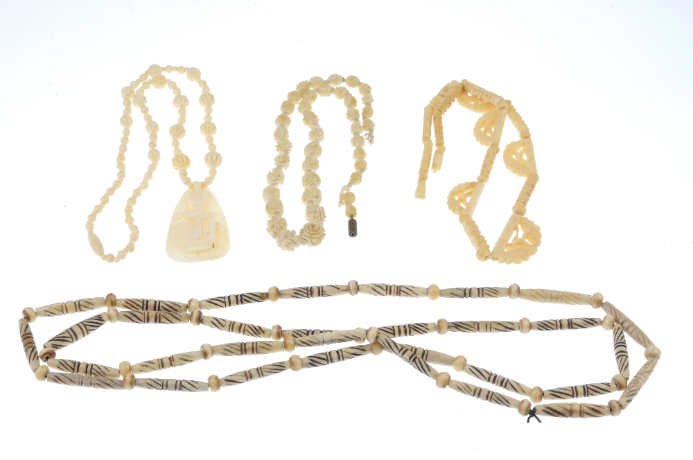 A selection of bone jewellery. To include three bangles, various carved bead necklaces, carved panel - Image 2 of 3