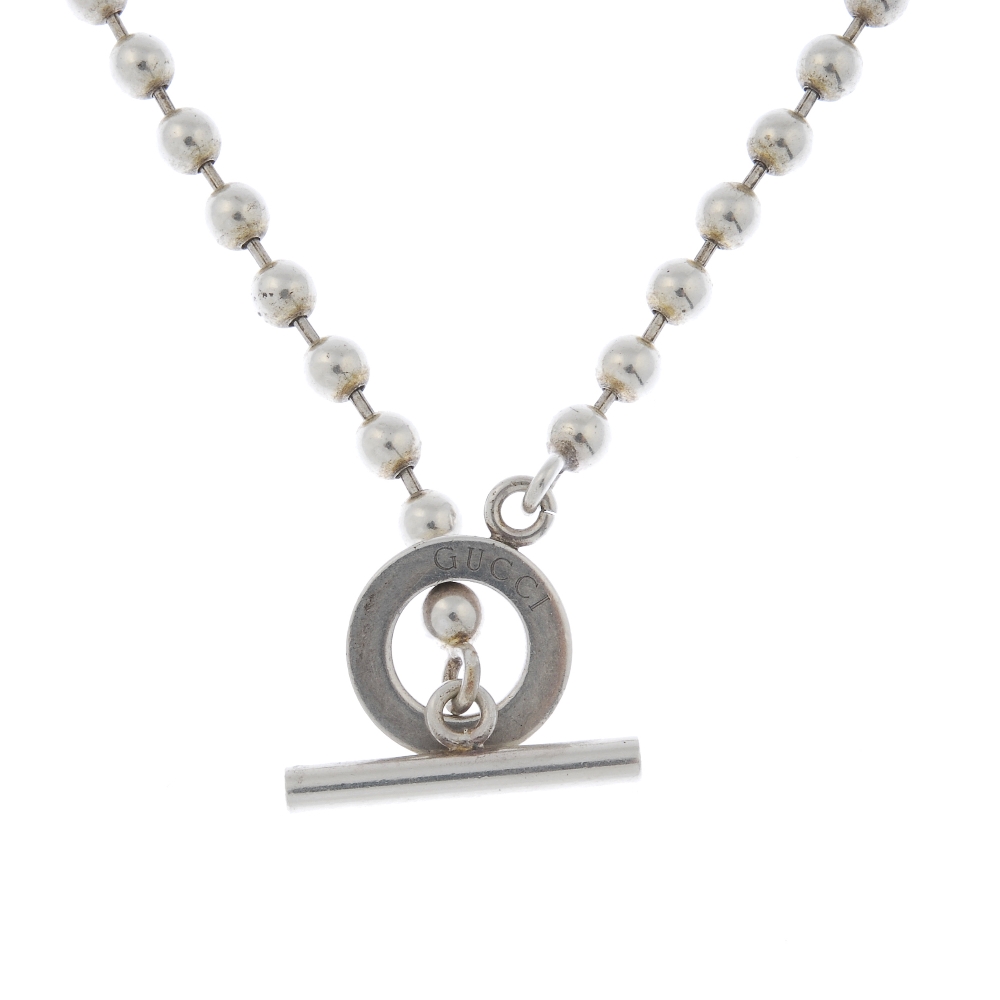 GUCCI - a silver necklace and bracelet set. The silver necklace designed as a series of spherical