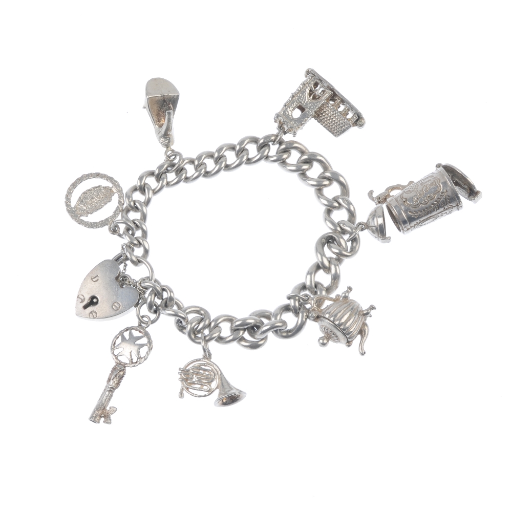 Four charm bracelets. Suspending a total of forty charms, to include a skier within a stein, an