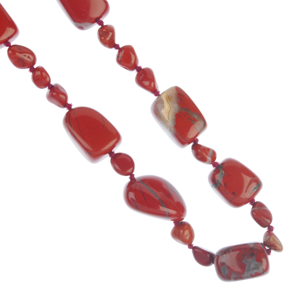 Four agate and hardstone necklaces. To include a dyed agate necklace, the magenta beads