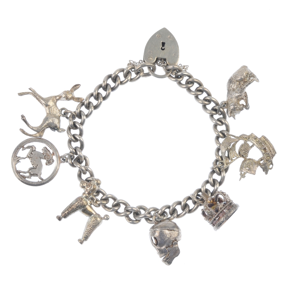 Three charm bracelets and some loose charms. Suspending twenty-two charms, to include a key, a