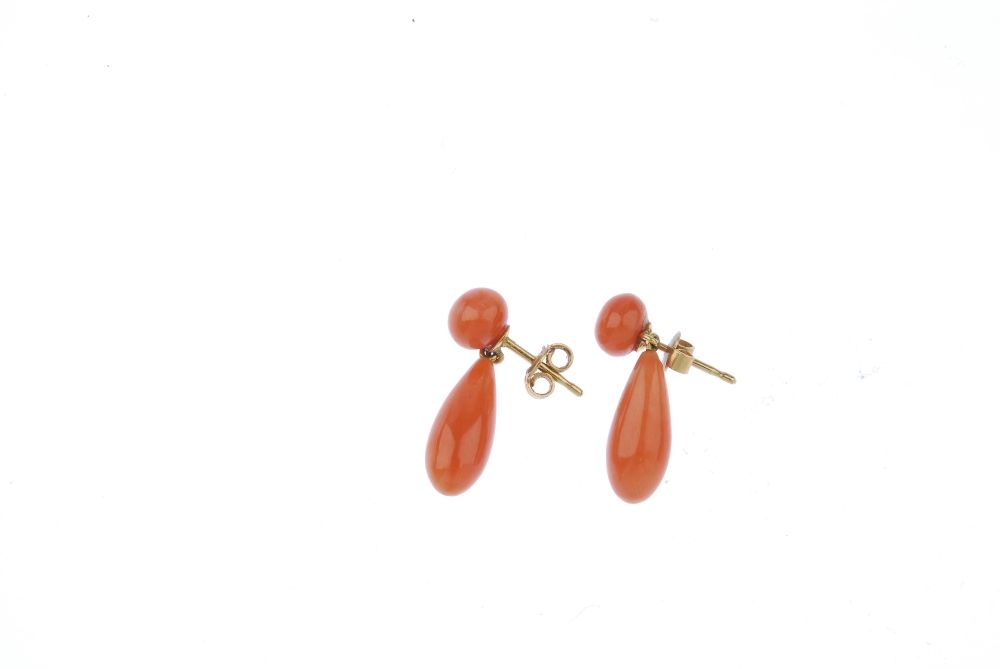 A pair of coral ear pendants. Each designed as a coral drop, suspended from a coral bead surmount. - Image 2 of 2