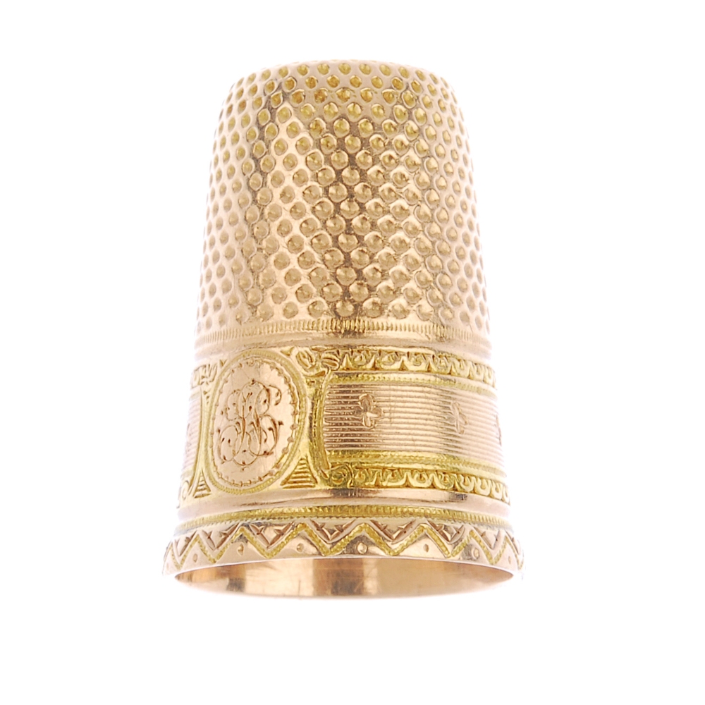 An early 20th century gold thimble. With engraved initial monogram and foliate border detail. Length