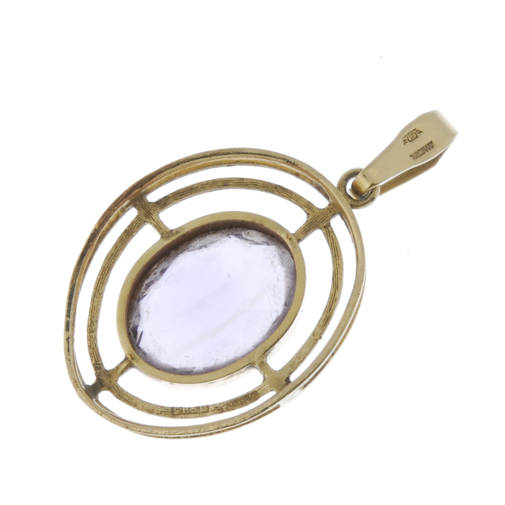 A 9ct gold amethyst pendant. The oval-shape amethyst, within an openwork surround, to the - Image 2 of 2