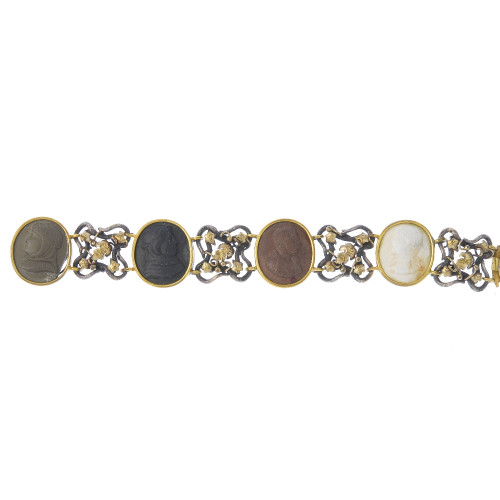 A lava cameo bracelet. Comprising four oval-shape lava cameo panels, of varying tones depicting