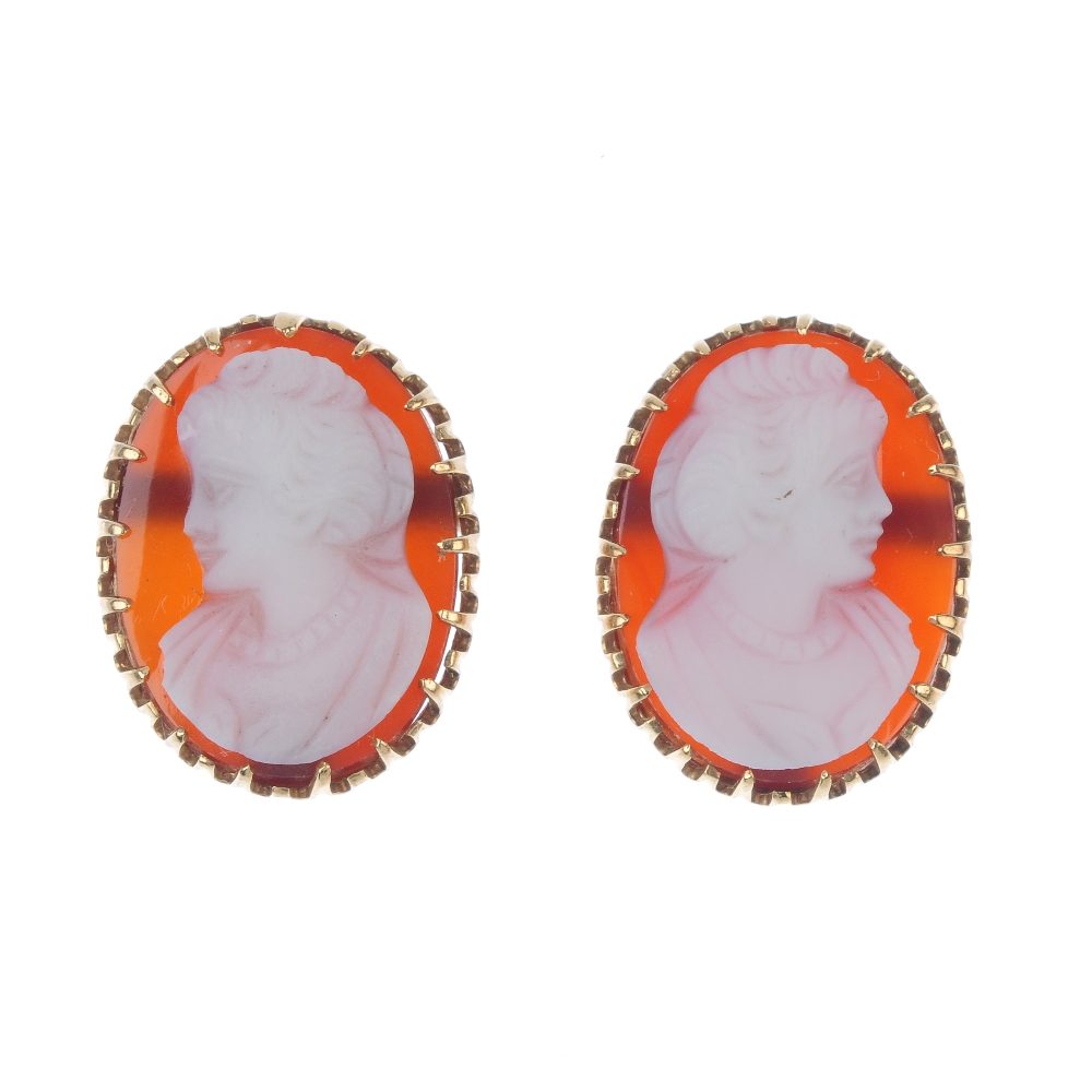 A pair of hardstone cameo ear studs. Each designed as a hardstone cameo carved to depict the side