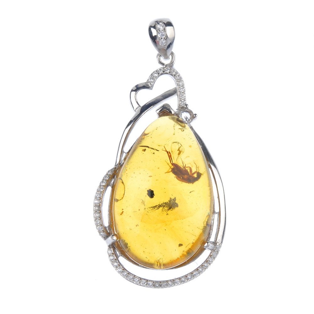 A natural Burmese amber pendant with inclusion. The pear-shape amber cabochon, with clearly