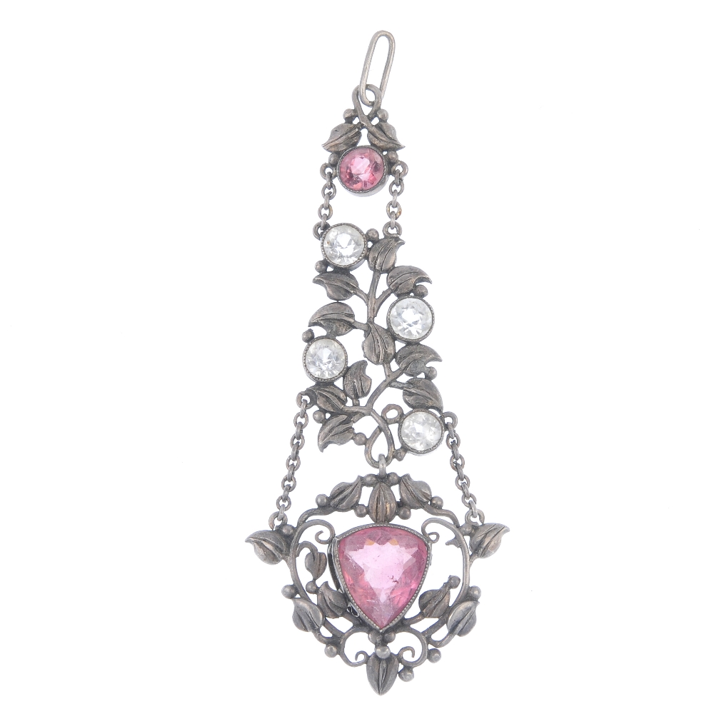 An early 20th century silver tourmaline and topaz pendant. The central triangular pink tourmaline