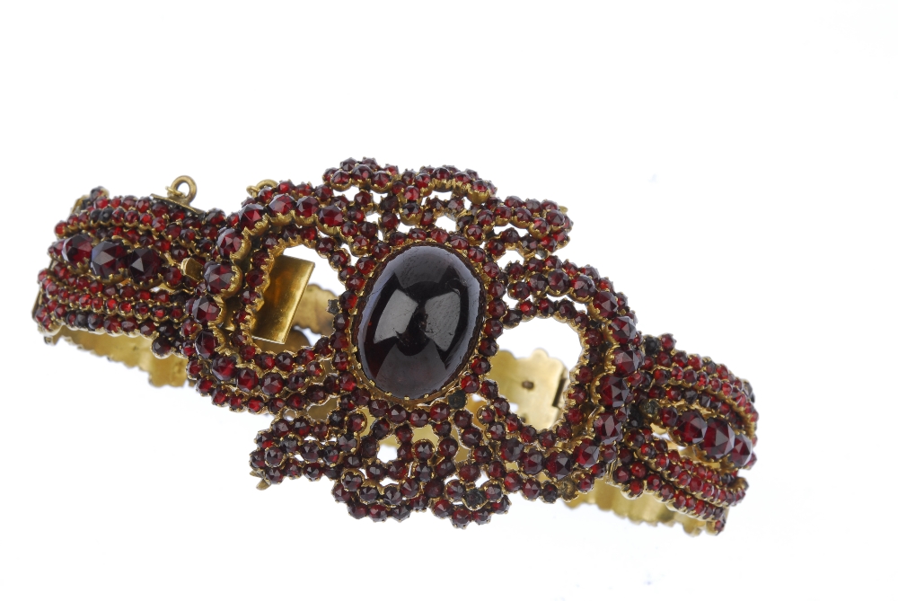 A garnet and paste bracelet. The oval garnet cabochon, within a circular-shape red paste and - Image 3 of 3