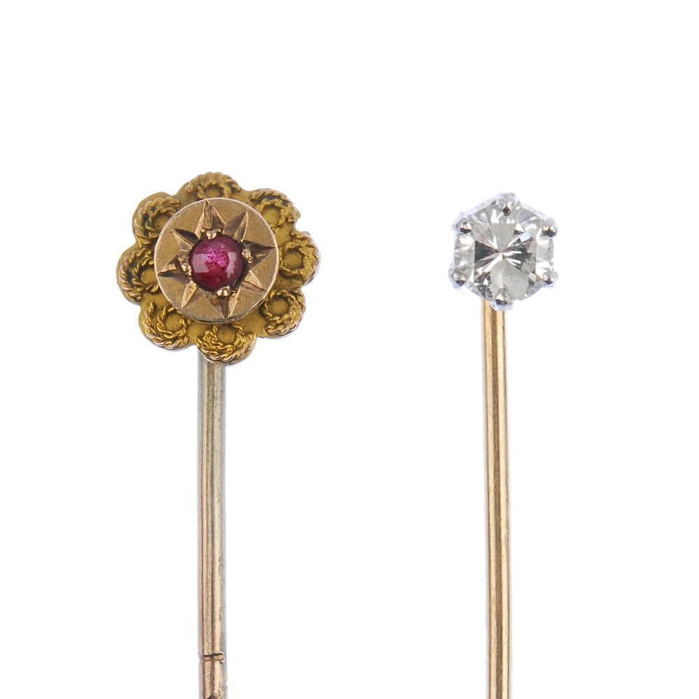 Two stickpins. The first designed a single brilliant-cut diamond stickpin, the second of floral