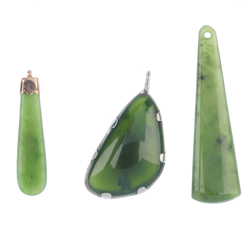 Three nephrite jade pendants. To include a late 19th century gold mounted pendant of pear-shape