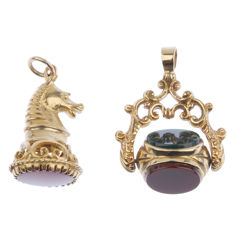 Two 9ct gold gem-set fobs. The first designed as a circular carnelian to the horse head shaped grip,