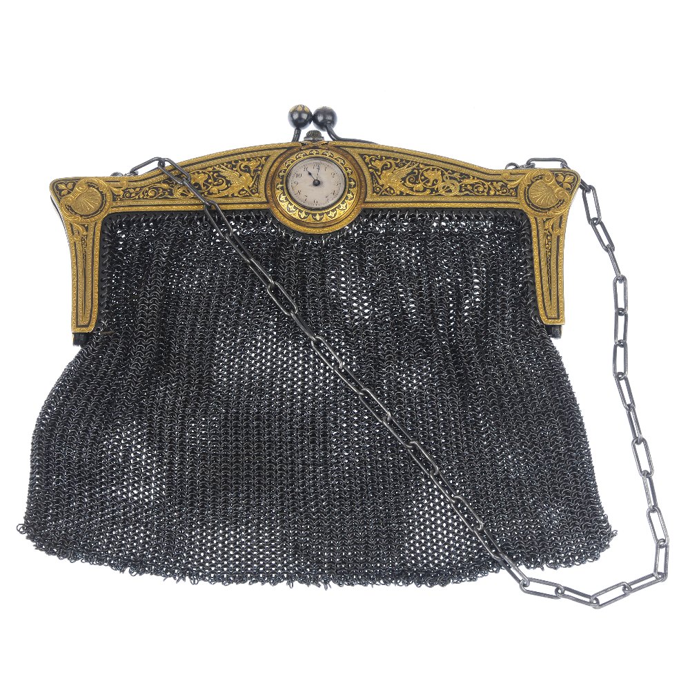 An early 20th century mesh bag. The dragon and foliate decorative frame with watch head detail, to
