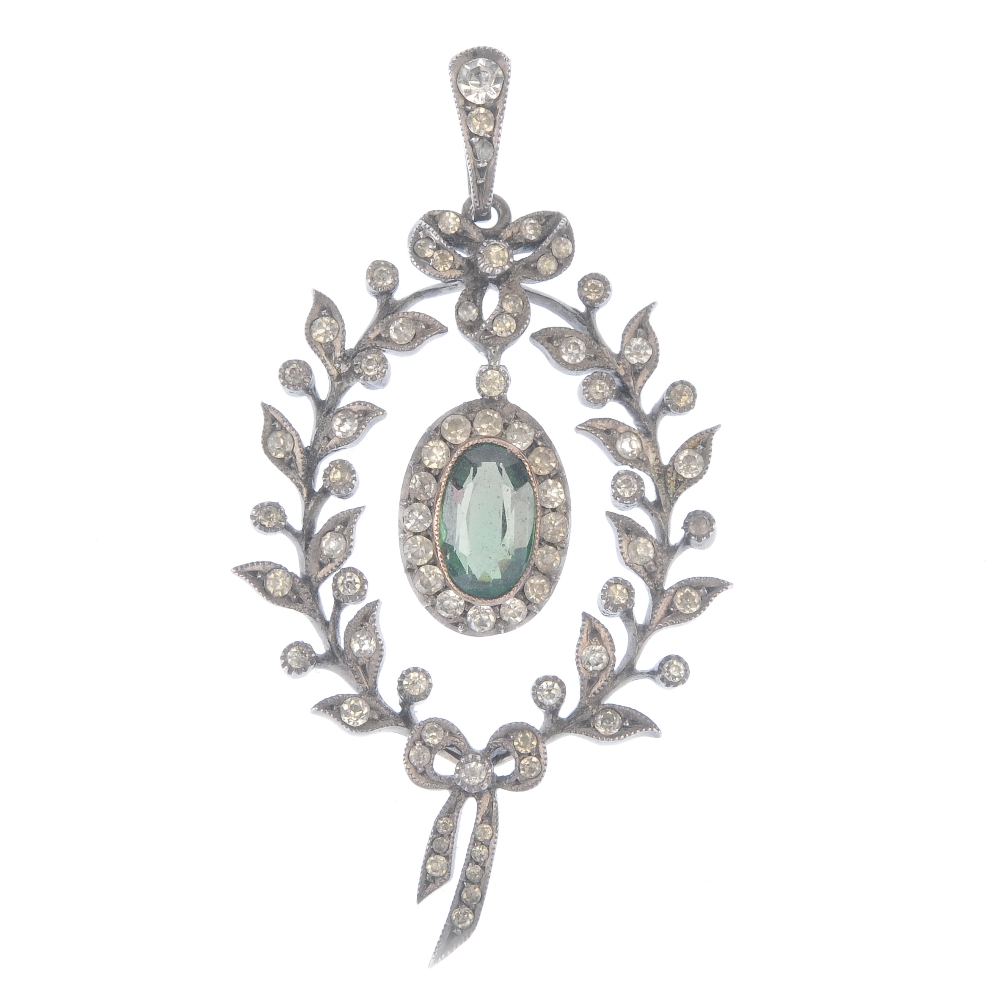 An early 20th century silver paste pendant. The oval-shape green and colourless paste cluster,