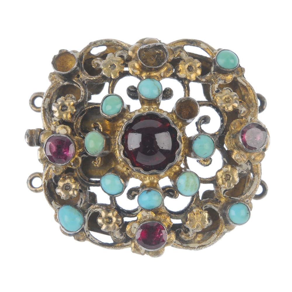 An Austro-Hungarian garnet and turquoise clasp. Of openwork floral design, the circular garnet