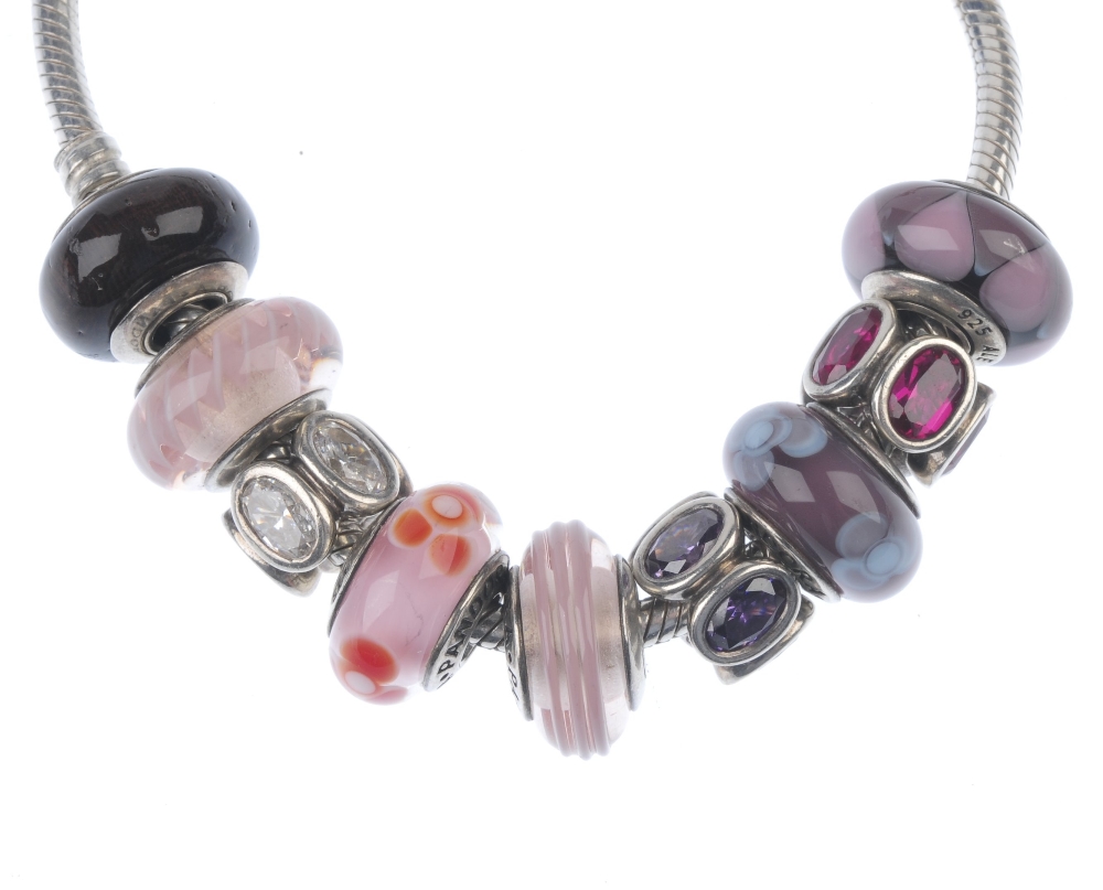 PANDORA - a charm bracelet. With nine charms including five glass charms, one wooden charm and three - Image 2 of 2