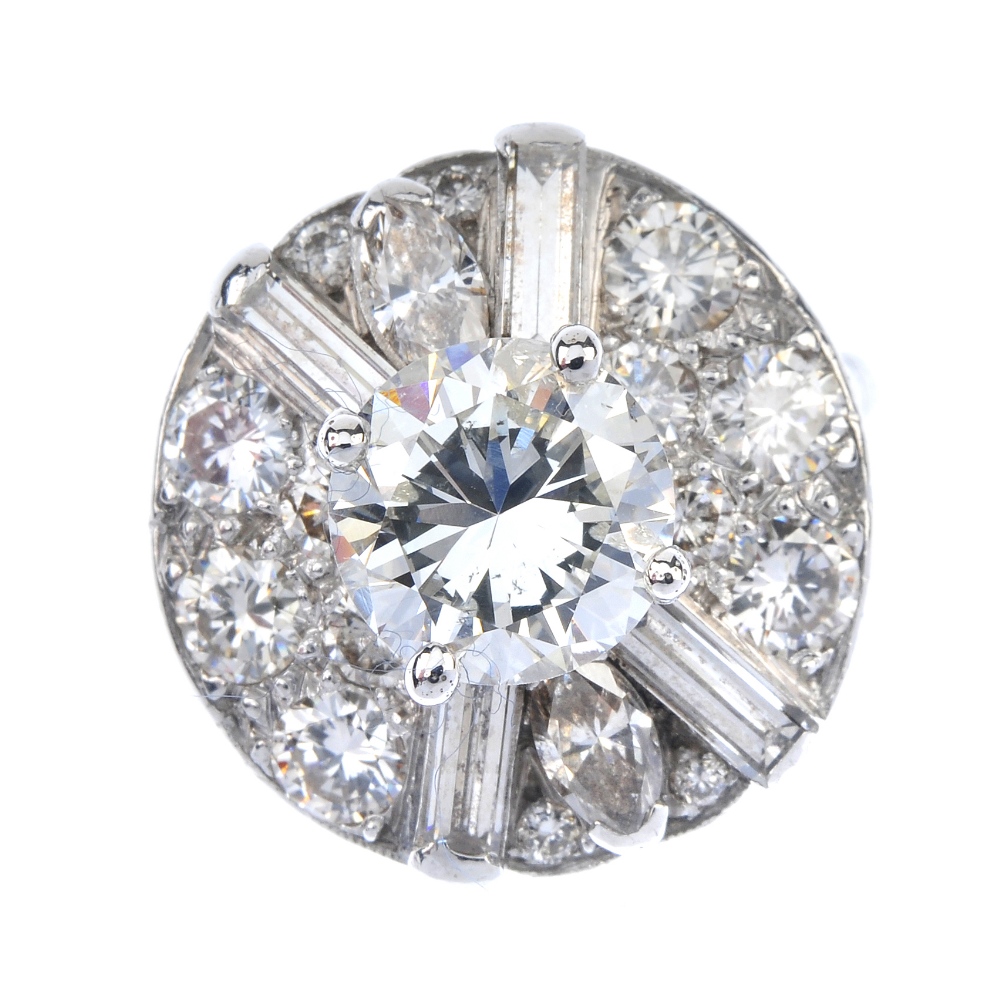 A diamond cluster ring. The brilliant-cut diamond, weighing 2.06cts, raised to the pave-set