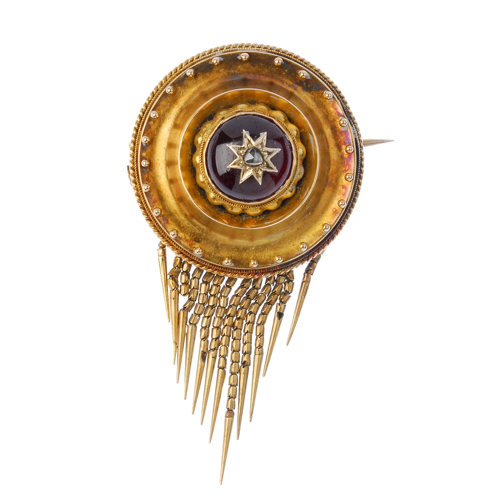 A late 19th century gold garnet and diamond brooch. Of circular outline, the rose-cut diamond