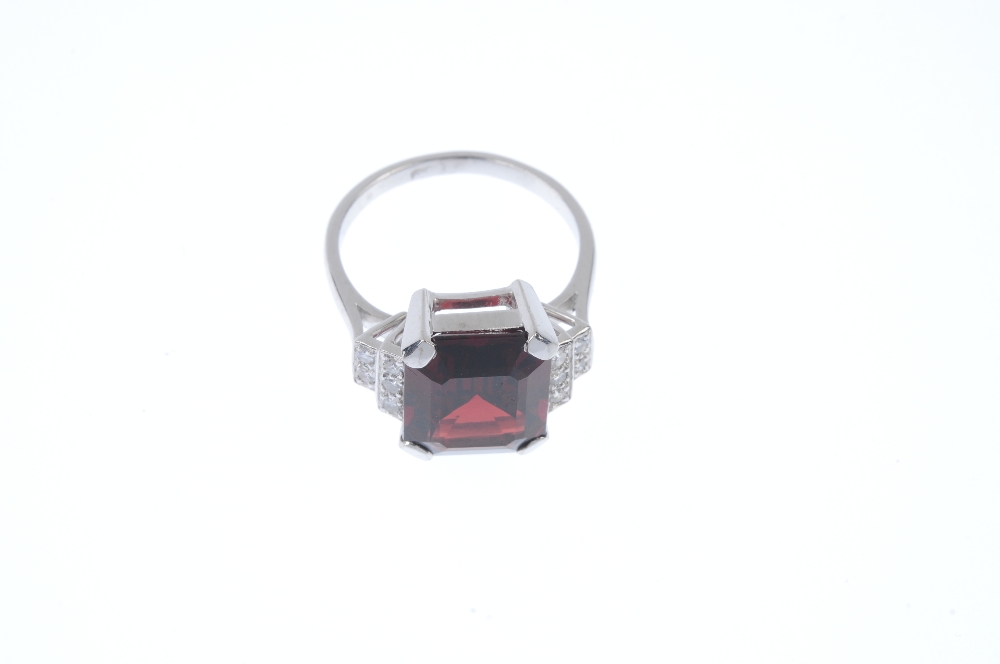 A garnet and diamond dress ring. The rectangular-shape garnet, to the single-cut diamond tiered - Image 2 of 4