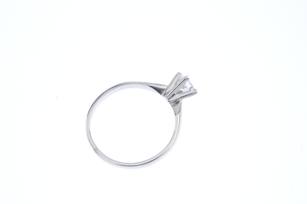 A platinum diamond single-stone ring. The square-shape diamond, weighing 0.59ct, to the plain - Image 4 of 5