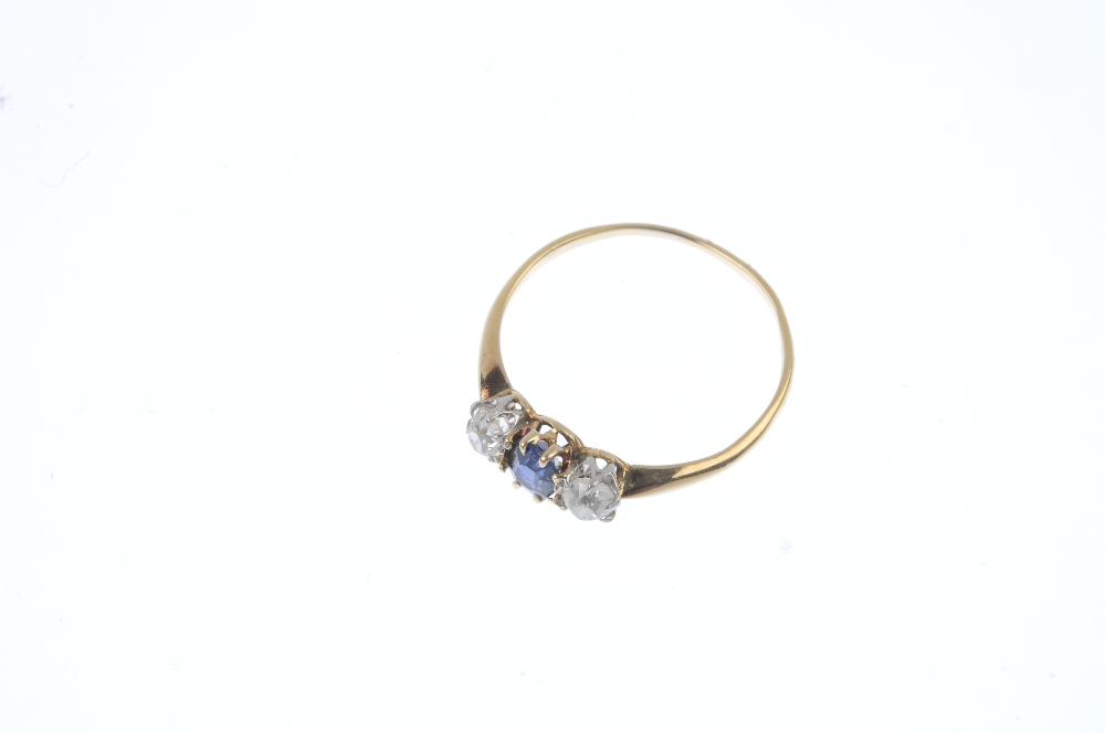 A sapphire and diamond three-stone ring. The oval-shape sapphire, with old-cut diamond sides, to the - Image 2 of 4