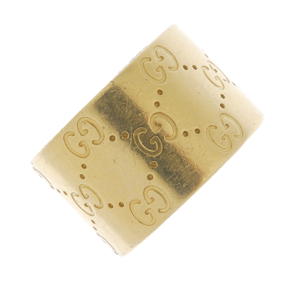 GUCCI - an 18ct gold 'Icon' band ring. The wide band, decorated with signature double 'G' motif