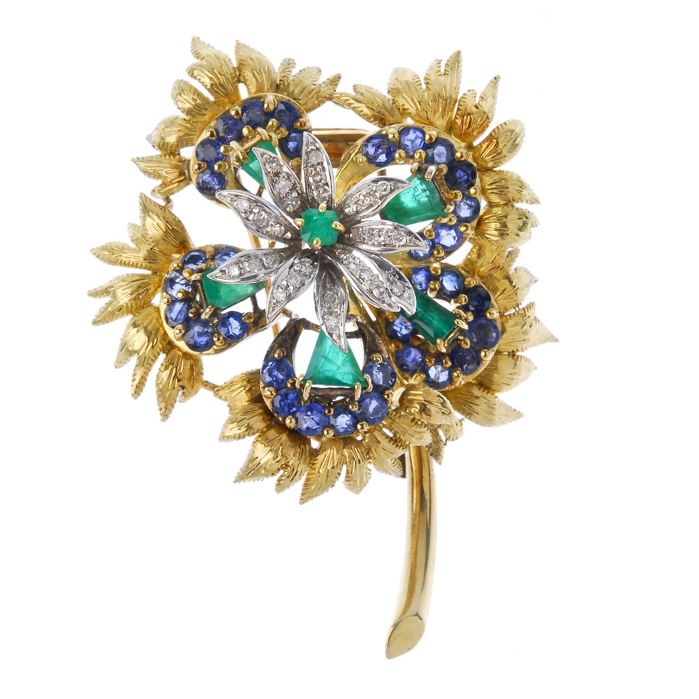 A mid 20th century diamond, emerald and sapphire spray brooch. The square-shape emerald and single-