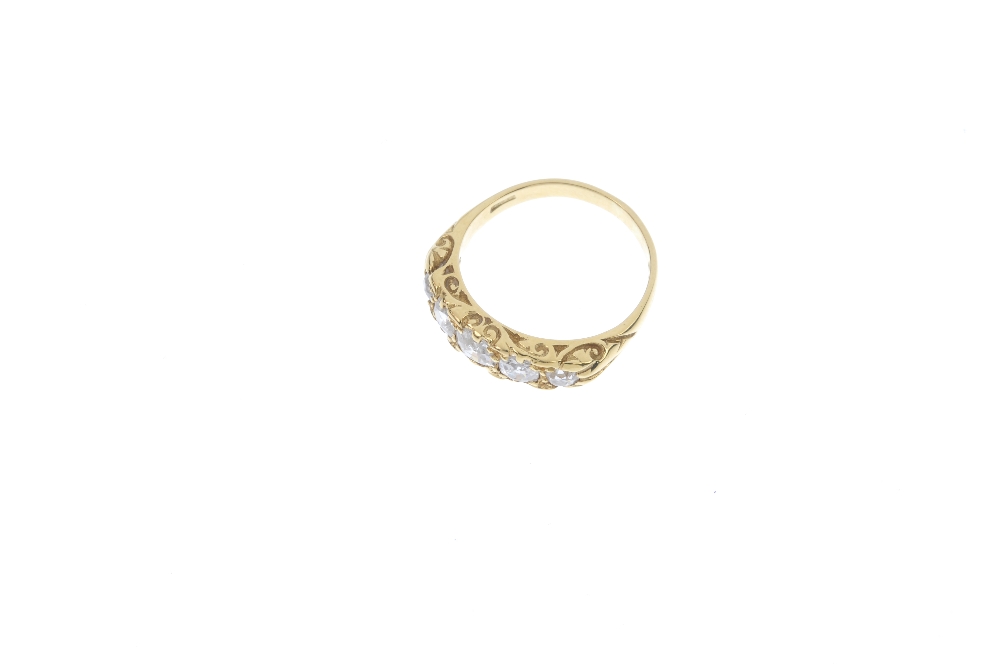 An 18ct gold diamond five-stone ring. The graduated old-cut diamond line, to the scrolling gallery - Image 2 of 4