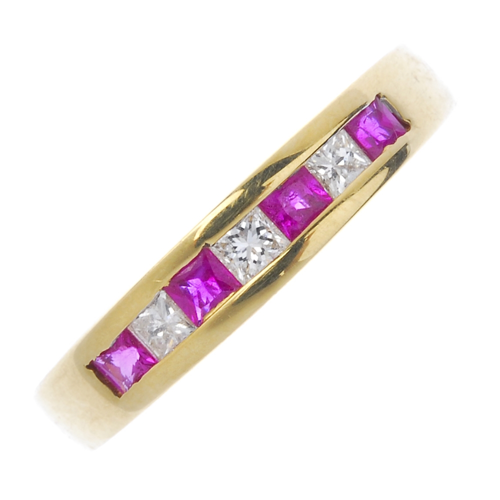 An 18ct gold ruby and diamond half-circle eternity ring. The alternating square-shape ruby and