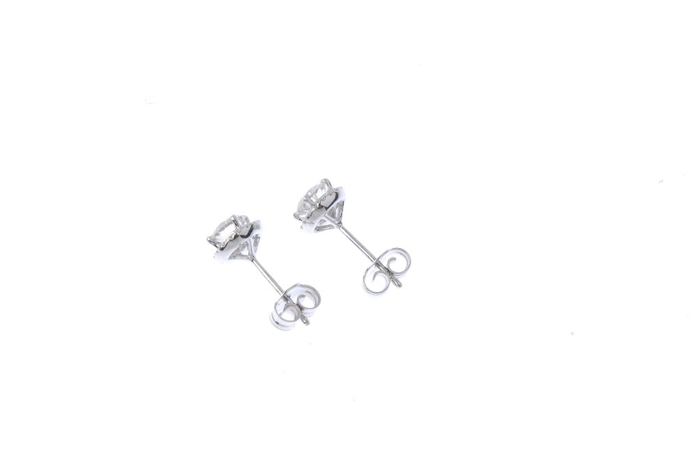 A pair of diamond cluster ear studs. Each designed as a brilliant-cut diamond, with similarly-cut - Image 2 of 2