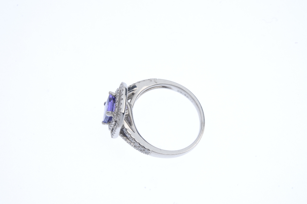 An 18ct gold tanzanite and diamond cluster ring. The square-shape tanzanite, within a brilliant- - Image 3 of 4