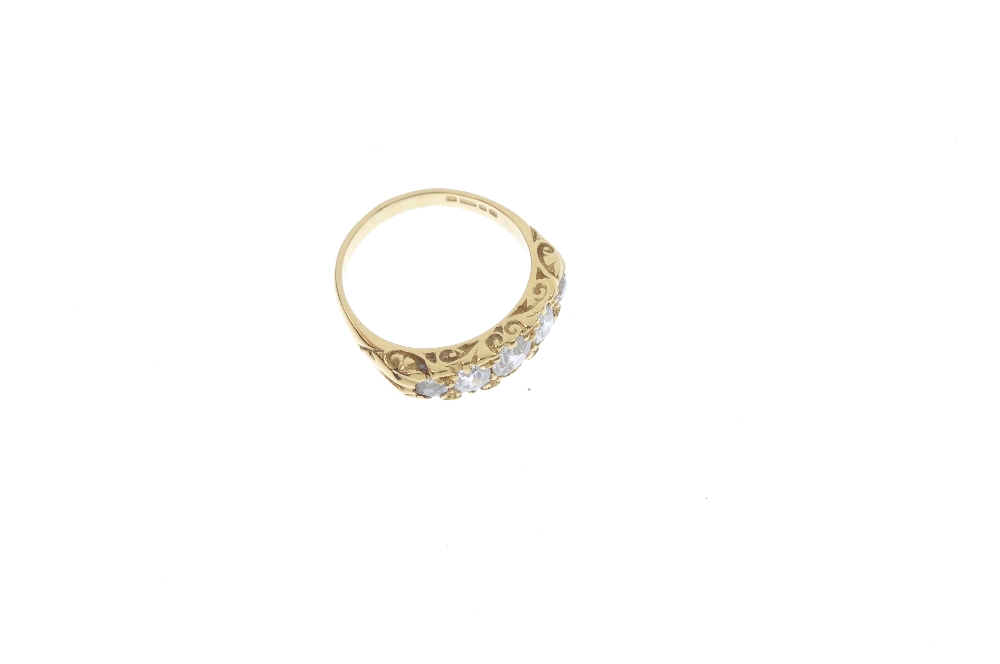 An 18ct gold diamond five-stone ring. The graduated old-cut diamond line, to the scrolling gallery - Image 3 of 4