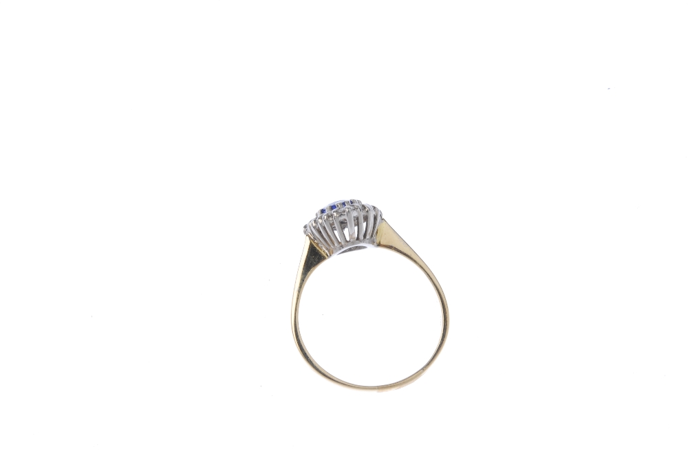 An 18ct gold sapphire diamond cluster ring. The pear-shape sapphire, within a brilliant-cut - Image 4 of 4