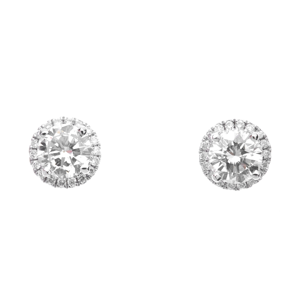 A pair of diamond cluster ear studs. Each designed as a brilliant-cut diamond, with similarly-cut