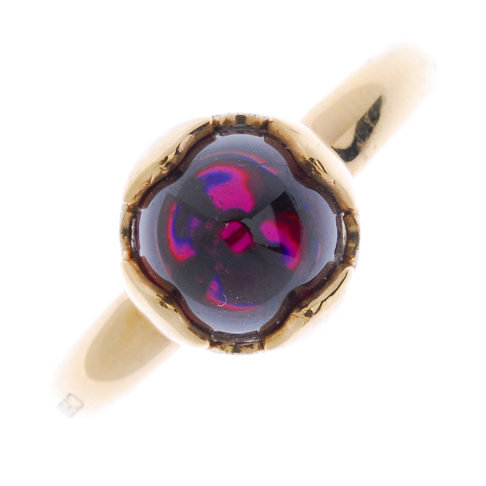 CHIMENTO - an 18ct gold garnet single-stone ring. The garnet cabochon, within a vari-texture petal