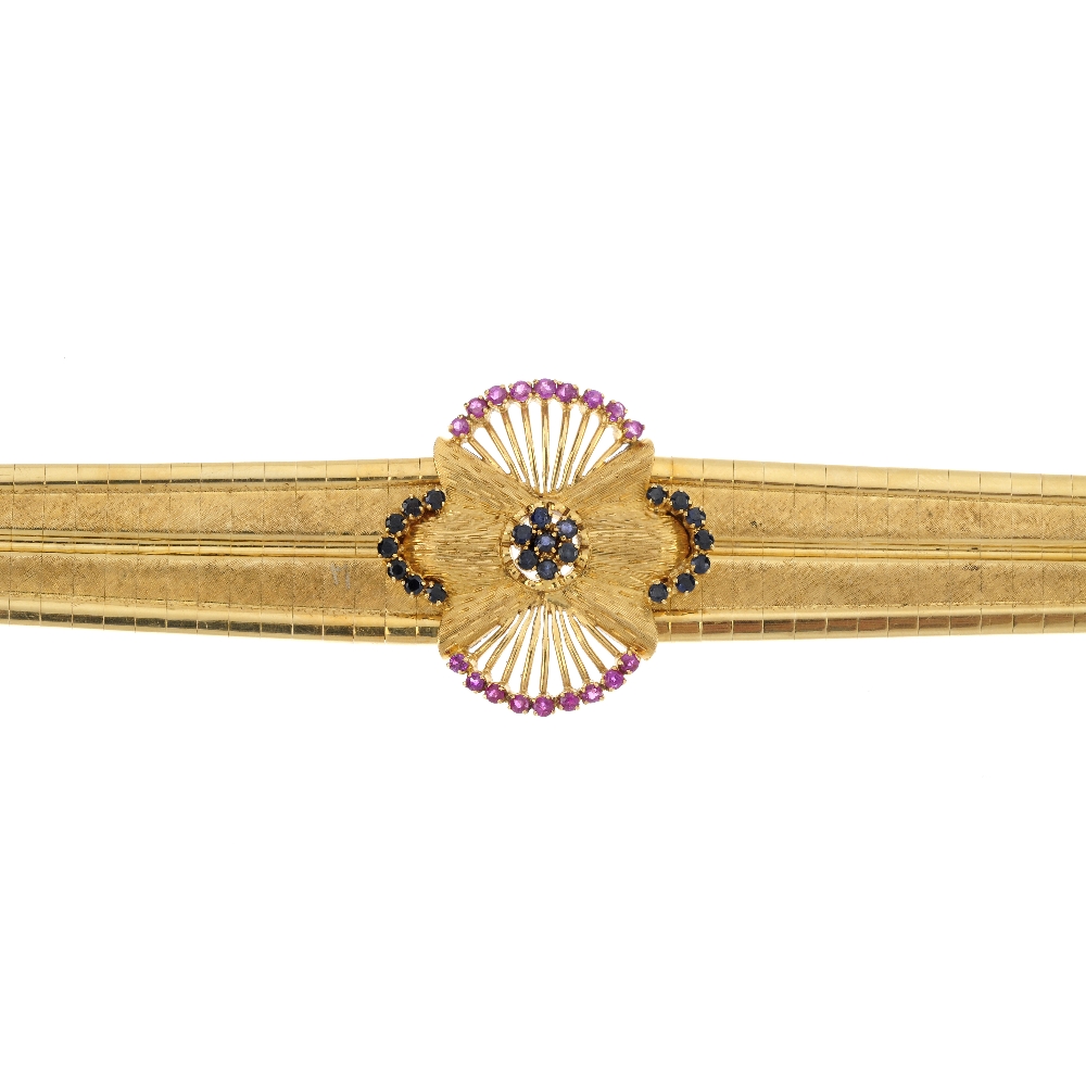 A mid 20th century ruby and sapphire bracelet. The circular-shape sapphire cluster, within a