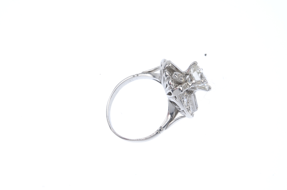 A diamond cluster ring. The brilliant-cut diamond, weighing 2.06cts, raised to the pave-set - Image 4 of 5