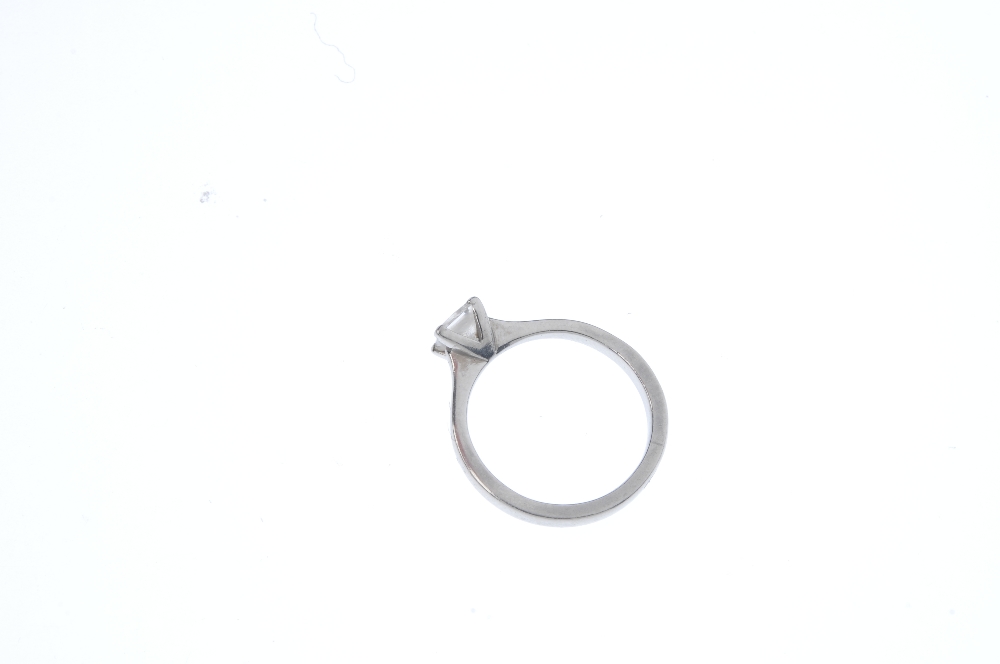 A platinum diamond single-stone ring. The square-shape diamond, weighing 0.55ct, to the tapered - Image 4 of 5