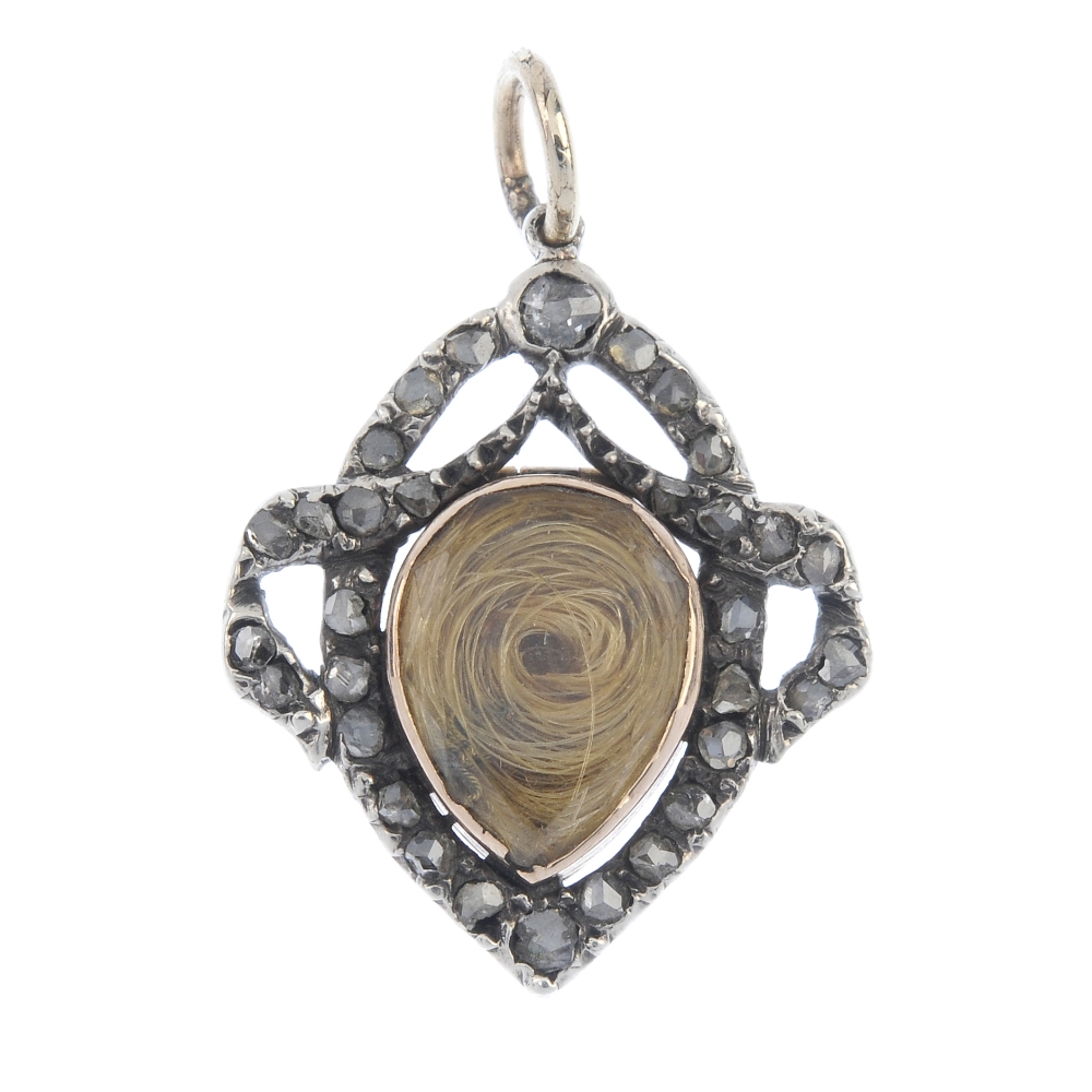 A late Victorian silver and gold diamond memorial pendant, circa 1900. The pear-shape hair panel,